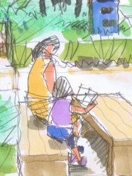 木陰で絵本を読む母子。